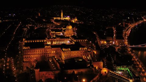 Budapest, Hungary, Europe - aerial panoramic skyline view of illuminated Buda Castle Royal Palace and Matthias Church stock video. 