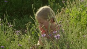 Happy Little Girl Playing Outdoor, Smelling Poppy Flower Flower Field, Summer, Spring Landscape, Slow motion.