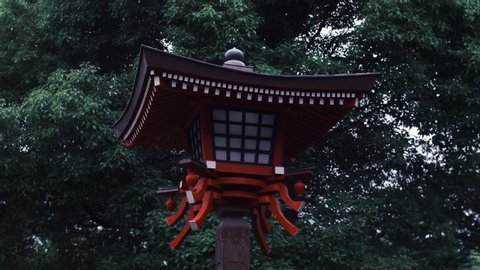 Low Angle View Of Red Wood Lantern In Ueno Park Against Trees, Tokyo, Japan