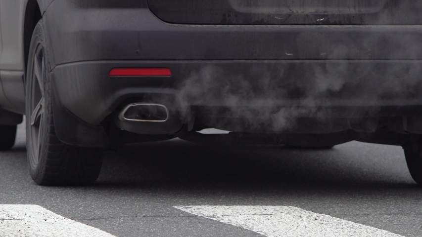 car exhaust from exhaust pipe. toxic smoke pollutes atmosphere. smog. air pollution problem. global warming concept. dirty air. toxic fumes. toxic waste. global climate change problem. save ecology Royalty-Free Stock Footage #1045782616