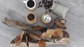 Top view spinning video of wooden branches with coffee cup and coffee beans. FHD.