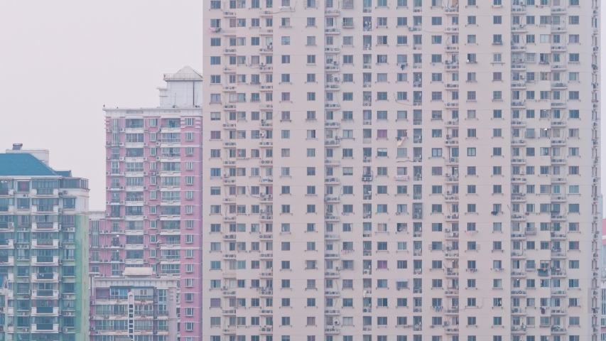 Day to night transition time lapse of Shanghai apartment buildings. Chinese crowded city with lights turning on and off at night. 4k time lapse in urban metropolis. Royalty-Free Stock Footage #1045794757