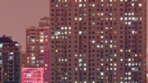Day to night transition time lapse of Shanghai apartment buildings. Chinese crowded city with lights turning on and off at night. 4k time lapse in urban metropolis.