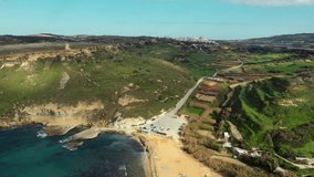 Aerial view of Gnejna bay beach. Winter, a lot of greeny, hills and fields, blue sea. Malta 