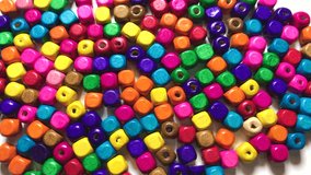 Buying Macro Detail shot 4K video made of colorful conference beads composition on white table.