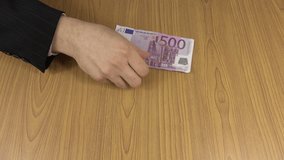 Successful salesman man count euro cash money banknotes on table. Businessman in suit count daily income. Business, office, household, banking, tax, gamble concept. Closeup shot. 4K UHD video clip.