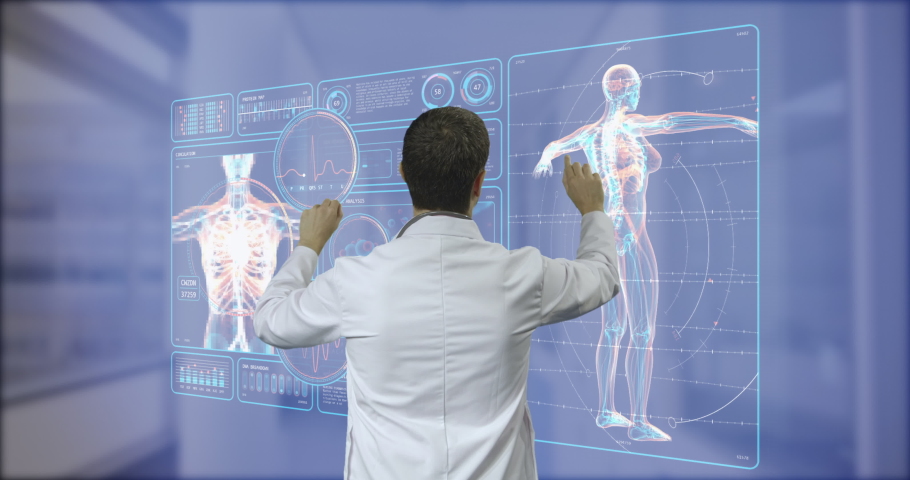 Surgeon doctor looking at futuristic medical charts at a high tech hospital