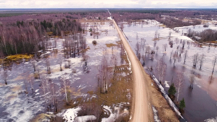 Aerial view of a road surrounded by water with snow Tipu, Viljandi County, Estonia
