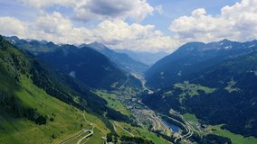 Flying over Val Bedretto and the city of Airolo in Switzerland. This mountain valley is located in the canton of Ticino in the Swiss Alps. 4K UHD video.