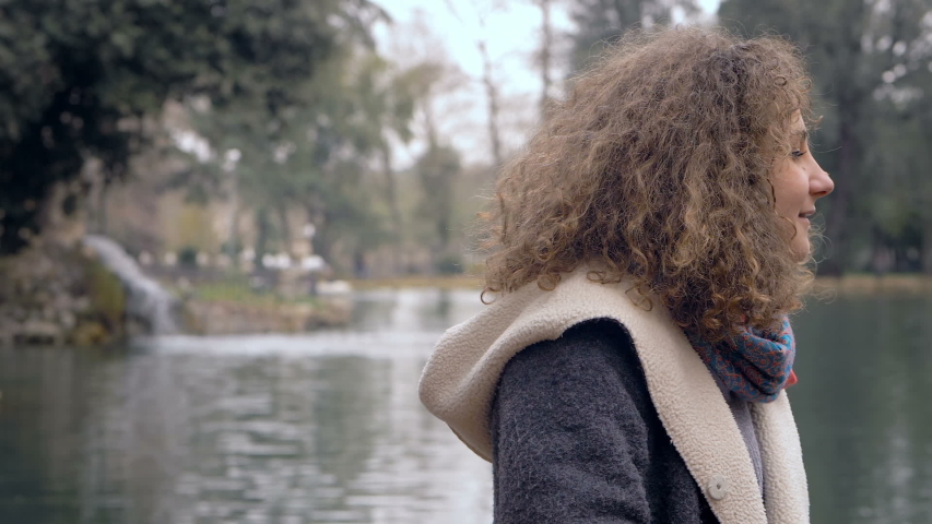 young smiling woman waiting for her friend sneaking up behing her 