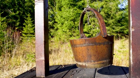 An old fountain with a wooden bucket