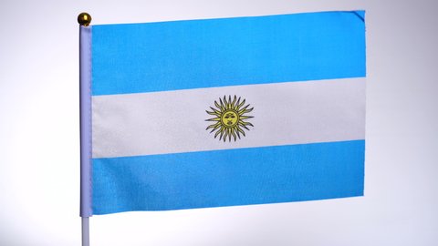 Argentinian flag on flagpole flying and waving in the wind. Flag Isolated on white