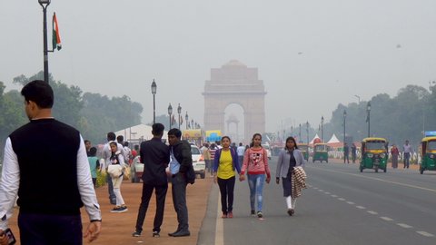 Telephoto of People Walking Towards India Gate in Distance With Lots of Air Pollution - New Delhi, India - March, 2019
