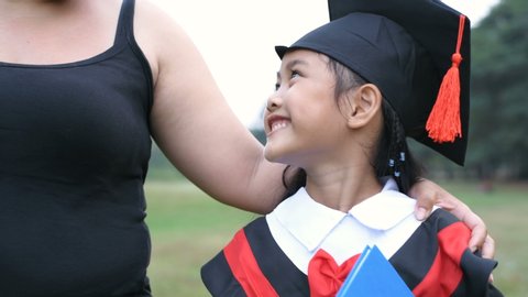 Educational concepts. Mother is congratulating her daughter on graduation day. 4k Resolution.