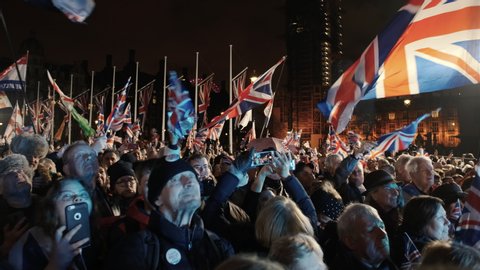 London, 31 Jan 2020 - BREXIT Day - Crowds waving flags to celebrate the UK departure from the European Union in Parliament Square, London, England, UK