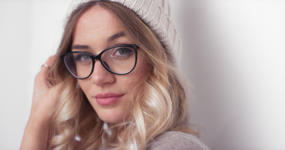Young Woman Covers Face With Hands As She Poses For Camera