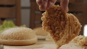 Close-up of breaded chicken chop spinning on table in slow motion