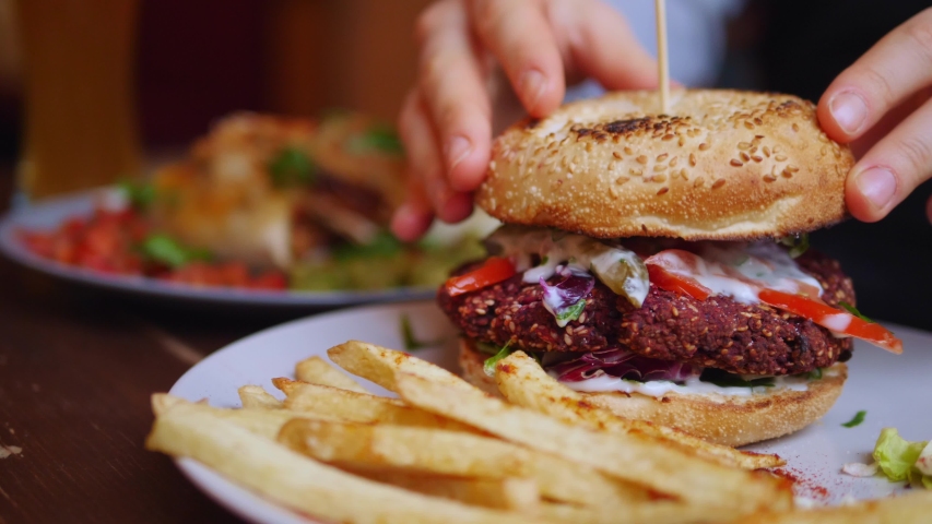 Eating Healthy Vegan Burger With French Fries . Closeup. Royalty-Free Stock Footage #1045906936