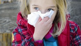 Girl blowing his nose into a paper handkerchief in winter - Powered by Shutterstock - Get 15% off with code: PIKWIZARD15