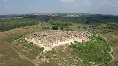 Drone shot of ancient archaeological site called Kamyana Mohyla or literally stone tomb, encompassing group of isolated blocks of sandstones, up to twelve meters in height, Melitopol region, Ukraine