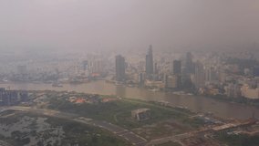 Aerial video of downtown Ho Chi Minh City in Vietnam on a cloudy hazy overcast day.