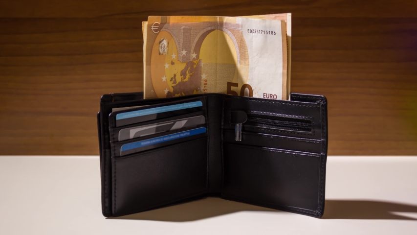 Euro banknotes come out of the wallet