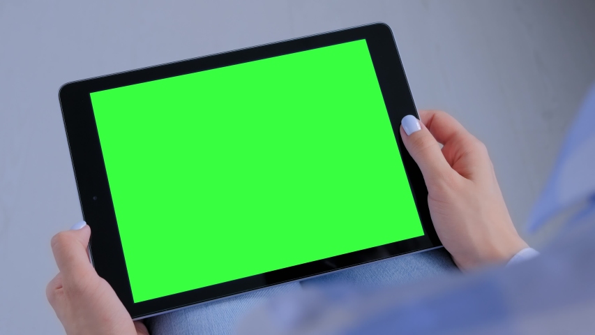 Green screen, mock up, entertainment, copyspace, freelance, template, leisure time, technology concept. Woman sitting on floor and looking at black tablet computer device with blank green display Royalty-Free Stock Footage #1045926022