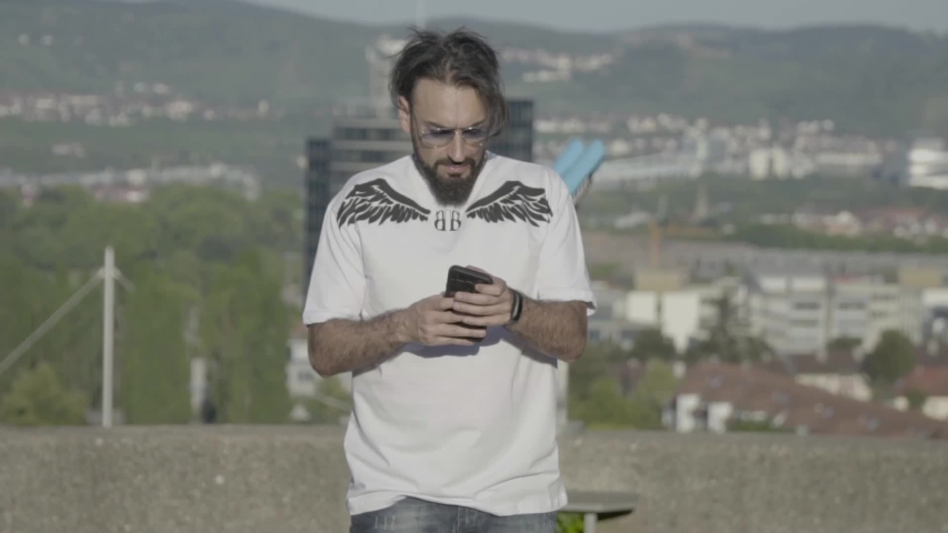 A turkish man checking his mobile phone. The model is the turkish rapper Musab Geeflow.