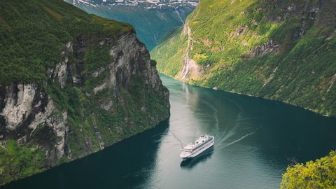 Geirangerfjord, Norway. Touristic Ship Ferry Boat Cruise Ship Liner Floating Near Geiranger In Geirangerfjorden In Summer Day. Famous Norwegian Landmark And Popular Destination. 4K วิดีโอสต็อก