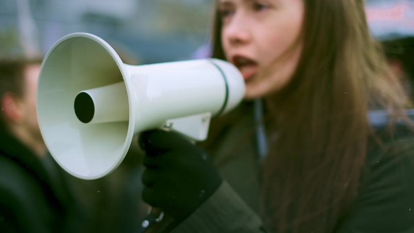 Young adult female feminist demonstration. Gender rights feminism fight. Women march movement power sign equality. Gender woman strike empowerment action. Social message. Crowd people city street day. Royalty-Free Stock Footage #1045954465