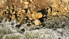 Sky view on the wild sea beach. Cinematic video about wild nature. Ukrainian landscape. Huge boulders. Rocky beach. Active holiday