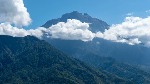 Time lapse : Majestic Mount Kinabalu view with mountains layer below and clouds in motion. Nature composition. 4K Resolution. 