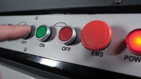 professional worker at furniture factory turns off electric wood cutting machine. man presses Off button with his fingers. The construction and manufacturing sectors. enabling and disabling hardware - Powered by Shutterstock - Get 15% off with code: PIKWIZARD15