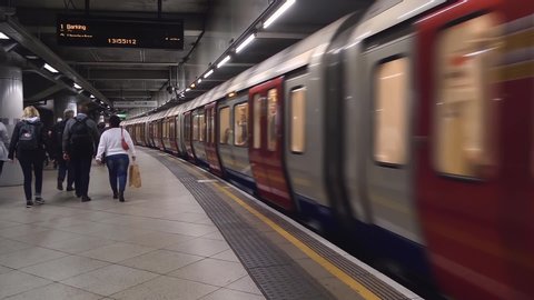 London, UK - April, 2019: Departure and arrival of trains in London Underground on different railway tracks. Inside view of London underground. Train leaving platform at station on London Underground.