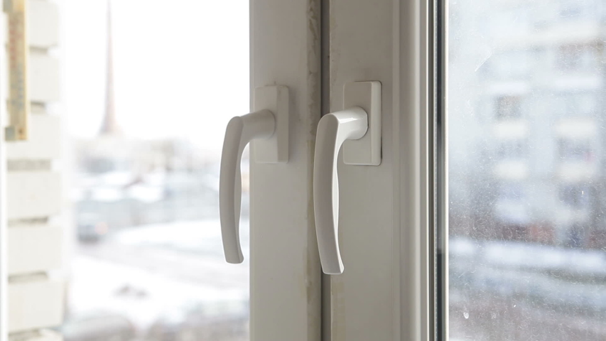 A man opens a window to ventilate the room. Winter fresh air enters the room.
 Royalty-Free Stock Footage #1045987492