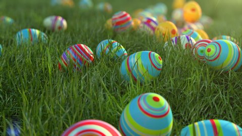 Easter eggs on the grass. Easter eggs slide down the slope covered with green cereal. Sunny positive climate. Beautiful surroundings and cheerful animation.