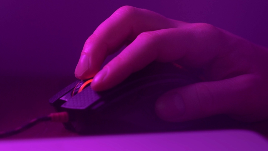 Close up of Hand over wireless Game Mouse on dark background The finger ready to click