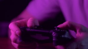 Man hands holding joystick gamepad for playing video games, professional cyber sports athlete champion play and win game