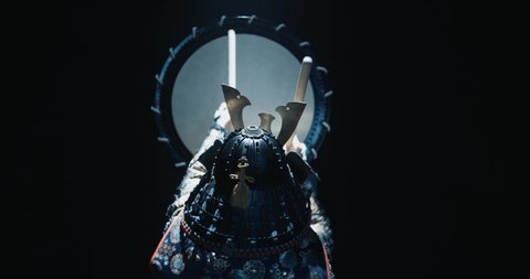 Japanese man in historical samurai costume playing on taiko drum with kata moves, isolated on black background - culture, history concept 4k footage