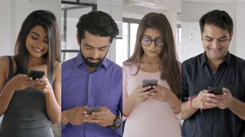 corporate employees using mobile phone or smartphone to group chat on WhatsApp. A group of Indian corporate colleagues working in collaboration on an assignment using a cellphone to text each other.