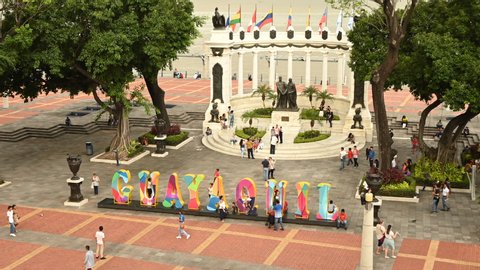 Guayaquil , Guayas / Ecuador - 06 05 2019: Timelapse of people visiting the Rotonda Monument and the letters Guayaquil in Malecon Simon Bolivar, Guayaquil. People taking pictures, tourist passing by a