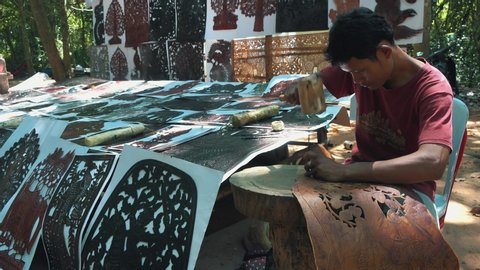 Siem Reap / Cambodia - 11 04 2019: Cambodian Artist Near Angkor Wat Using Stencils to Decorate Leather