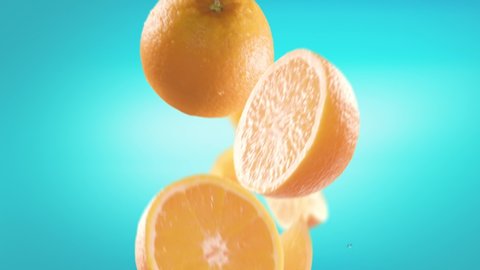 Flying of Orange and Slices in Ice Blue Background