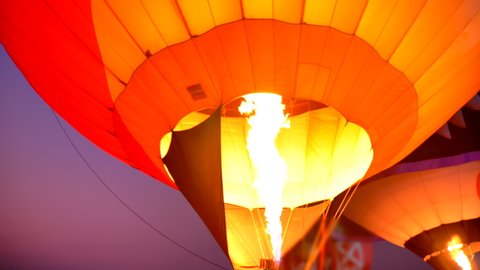 Scene slow motion of flame rising and inflating hot air balloon