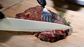 Slicing Fresh Cooked Tom-A-Hawk Steak Closeup Video.