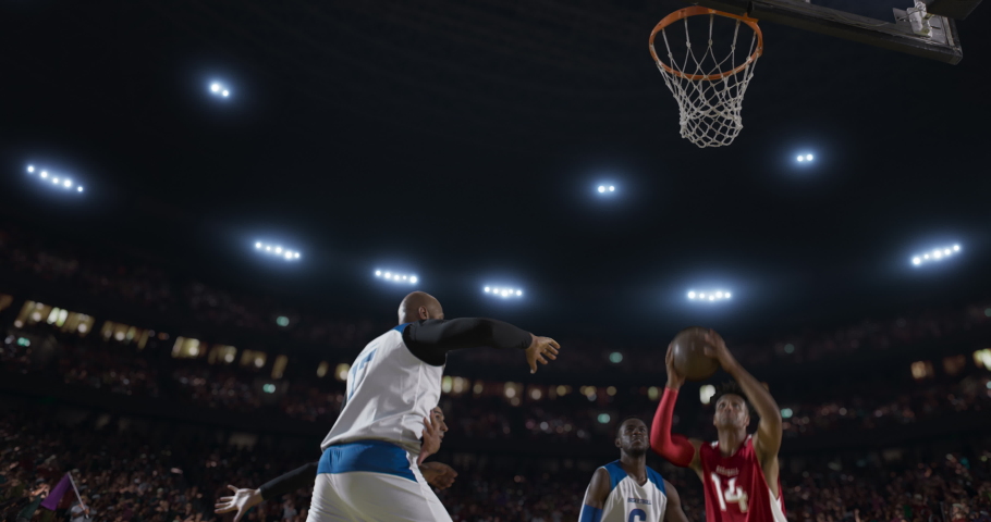 Basketball players on big professional arena during the game. Tense moment of the game. View from below the basket Royalty-Free Stock Footage #1046031361