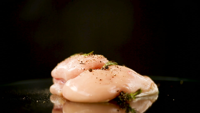 Chicken fillet with spices and rosemary on a dark Royalty-Free Stock Footage #1046032681