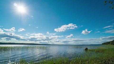 4k Timelapse of Sun moving over wild lake. Nature of Karelia. Shore of Lake Ladoga, Russia. Republic of Karelia. Northern nature near Finland border