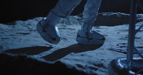 Medium close up shot of astronaut walking on the Moon