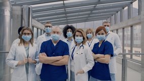 Group of doctors with face masks looking at camera, corona virus concept. - Powered by Shutterstock - Get 15% off with code: PIKWIZARD15